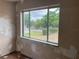 View of front yard through a large window in a room needing repair at 447 E Desoto St, Clermont, FL 34711