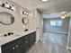 Updated bathroom with double vanity, modern fixtures, and neutral decor creates a serene and functional space at 519 Hawthorne Blvd, Leesburg, FL 34748