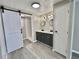 Bathroom includes double vanity sinks and a sliding barn door to the shower at 519 Hawthorne Blvd, Leesburg, FL 34748