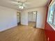Bedroom with closet doors with mirrors and a door leading to the hallway at 519 Hawthorne Blvd, Leesburg, FL 34748
