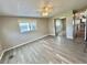 Bright bedroom featuring a ceiling fan, closet with mirrored doors and a view to an adjacent kitchen space at 519 Hawthorne Blvd, Leesburg, FL 34748
