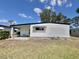 Rear exterior view of a well-maintained home with mature landscaping and ample yard space at 519 Hawthorne Blvd, Leesburg, FL 34748