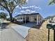 Inviting home exterior with a covered carport, green lawn, and a welcoming curb appeal at 519 Hawthorne Blvd, Leesburg, FL 34748
