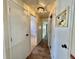 Hallway with tile floor and doors leading to different rooms at 519 Hawthorne Blvd, Leesburg, FL 34748