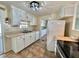 Charming kitchen with stainless steel appliances and bright white cabinets at 519 Hawthorne Blvd, Leesburg, FL 34748