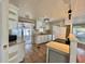 Well-lit kitchen with stainless steel appliances, tile floors, and sliding door at 519 Hawthorne Blvd, Leesburg, FL 34748