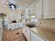 Well-maintained kitchen with stainless steel appliances, tile floors, and storage at 519 Hawthorne Blvd, Leesburg, FL 34748