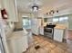 Bright kitchen with stainless steel appliances, white cabinetry, and tile flooring at 519 Hawthorne Blvd, Leesburg, FL 34748