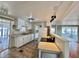 Bright kitchen features white cabinets and appliances, with a view into the living area at 519 Hawthorne Blvd, Leesburg, FL 34748