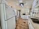 Functional kitchen featuring tile floors, bright cabinets, and essential appliances at 519 Hawthorne Blvd, Leesburg, FL 34748