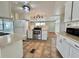 Bright kitchen with white cabinets, modern appliances, and tile flooring at 519 Hawthorne Blvd, Leesburg, FL 34748