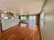 Spacious living room with hardwood floors adjoining an open kitchen at 519 Hawthorne Blvd, Leesburg, FL 34748