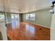 Bright living room featuring hardwood floors, a ceiling fan, and plenty of natural light at 519 Hawthorne Blvd, Leesburg, FL 34748