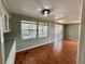 Open-concept living room features wood floors, natural light, and neutral paint at 519 Hawthorne Blvd, Leesburg, FL 34748