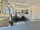 Close-up of covered parking area with golf cart and a well-kept home exterior at 519 Hawthorne Blvd, Leesburg, FL 34748