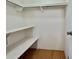 Walk-in closet featuring shelving and a light fixture at 519 Hawthorne Blvd, Leesburg, FL 34748