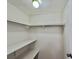 Walk-in closet featuring shelving and a light fixture at 519 Hawthorne Blvd, Leesburg, FL 34748
