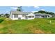 A cozy home featuring a green backyard on a sunny day at 529 Valencia Pl, Lady Lake, FL 32159