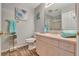 Bathroom featuring new vanity, modern toilet, and well-lit mirror at 529 Valencia Pl, Lady Lake, FL 32159
