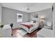 Cozy bedroom with hardwood floors, a comfy bed, and a ceiling fan at 529 Valencia Pl, Lady Lake, FL 32159