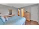 Bedroom boasts a comfortable bed, hardwood floors, and ensuite bathroom with closet at 529 Valencia Pl, Lady Lake, FL 32159