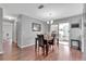 Inviting dining area with hardwood floors, slider door to lanai, and a modern light fixture at 529 Valencia Pl, Lady Lake, FL 32159