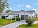 Charming home featuring a well-manicured lawn, concrete driveway, and a welcoming front facade at 529 Valencia Pl, Lady Lake, FL 32159