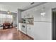 Well-lit kitchen with white cabinets and appliances, seamlessly connected to the dining area at 529 Valencia Pl, Lady Lake, FL 32159