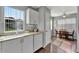 Bright kitchen with stainless steel appliances and ample counter space, with access to dining area at 529 Valencia Pl, Lady Lake, FL 32159