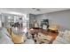 Inviting living area with hardwood floors seamlessly connected to the dining area and kitchen at 529 Valencia Pl, Lady Lake, FL 32159