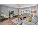 Inviting living room with gray walls, ceiling fan, hardwood floors, and plenty of natural light at 529 Valencia Pl, Lady Lake, FL 32159