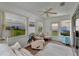 Cozy sunroom with ample seating, plush carpeting, and plenty of natural light at 529 Valencia Pl, Lady Lake, FL 32159