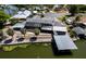 Waterfront home with a screened lanai, private boat dock, and lush landscaping along the water's edge at 5339 Kings Ct, Fruitland Park, FL 34731