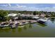 Stunning waterfront home featuring a screened lanai, private boat dock, and lush landscaping along the shoreline at 5339 Kings Ct, Fruitland Park, FL 34731