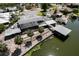 Waterfront home featuring a large screened lanai, covered boat dock, and nicely landscaped seawall at 5339 Kings Ct, Fruitland Park, FL 34731