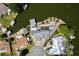 Aerial view of a lakefront property showcasing a boat dock, screened lanai, and surrounding neighborhood at 5339 Kings Ct, Fruitland Park, FL 34731