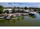 Stunning waterfront home featuring a screened lanai, private boat dock, and lush landscaping along the shoreline at 5339 Kings Ct, Fruitland Park, FL 34731