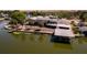 Scenic waterfront home featuring a spacious screened lanai, private boat dock, and lush green landscaping along the water's edge at 5339 Kings Ct, Fruitland Park, FL 34731
