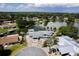 Breathtaking aerial view of waterfront property nestled among lush trees with private boat docks and serene lake at 5339 Kings Ct, Fruitland Park, FL 34731