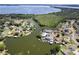 Stunning aerial view of waterfront homes with boat docks and lush greenery bordering a beautiful, sprawling lake at 5339 Kings Ct, Fruitland Park, FL 34731