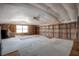 Large bonus room features bright carpet, a window, and shelving, offering ample space for hobbies at 5339 Kings Ct, Fruitland Park, FL 34731
