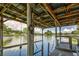 View under the boat dock overlooking peaceful water, with ample space for watercraft and relaxation at 5339 Kings Ct, Fruitland Park, FL 34731