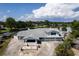 Aerial view of a gray roofed house featuring an attached garage, cozy porch, and waterfront access at 5339 Kings Ct, Fruitland Park, FL 34731