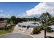 Aerial view of home with large driveway, manicured lawn, and mature landscaping on a sunny day at 5339 Kings Ct, Fruitland Park, FL 34731