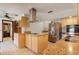 Modern kitchen with stainless steel appliances, granite countertops, and tile flooring at 5339 Kings Ct, Fruitland Park, FL 34731