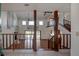 Sun-filled living room with two-story ceiling and hardwood floors and staircase at 5339 Kings Ct, Fruitland Park, FL 34731