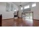 Cozy living room with wood floors, fireplace, and access to the screened-in lanai at 5339 Kings Ct, Fruitland Park, FL 34731