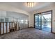 Loft room featuring a wooden railing, sliding door to the balcony and an open view to the living room at 5339 Kings Ct, Fruitland Park, FL 34731