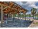 Waterfront outdoor seating area features a covered patio, picnic tables, and beautiful views perfect for relaxing at 5339 Kings Ct, Fruitland Park, FL 34731