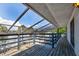 A covered patio overlooks water and lush landscaping. The backyard can be enjoyed while covered at 5339 Kings Ct, Fruitland Park, FL 34731